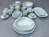 a picture of a table with a lot of white plates and bowls