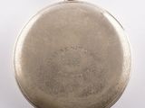 an old silver pocket watch with a chain on a white background