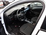 a white car with black seats and a steering wheel