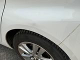 a close up of a car ' s wheel and tire on the street
