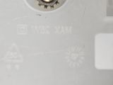 a close up of a white toilet with a metal spout