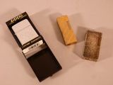 a lighter and a lighter case sitting on a table