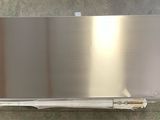 a stainless steel wall mounted dishwasher in a bathroom