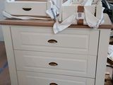 a white chest of drawers on a pallet in a room