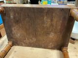 a wooden chair that has a wooden seat on it