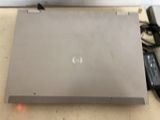 a laptop that is sitting on a table with a charger