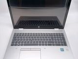 a laptop that is open on a white table