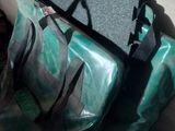 a bag of luggage sitting on the floor next to a pipe