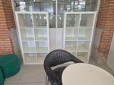 a black chair and a white table in the corner of a room