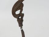 statue of a bird with a long tail on a clear base
