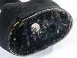 a close up of a piece of black material on a white surface