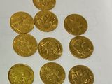 a lot of gold coins sitting on a white surface