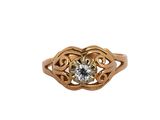 a close up of a gold ring with a diamond in the center