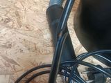 a black blow dryer sitting on the floor next to a bunch of wires