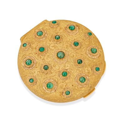 gold plated brooch with green stones on a white background