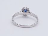 an image of a diamond and sapphire ring on a white surface