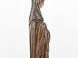 a statue of a woman in a robe and a hat