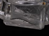 a glass block that is sitting on a black surface
