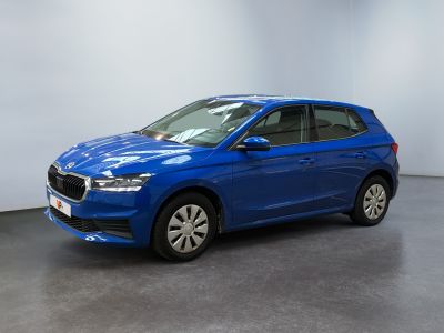 une voiture bleue garée dans une pièce aux murs blancs