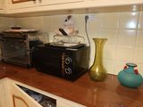 a microwave and a toaster sitting on a counter in a kitchen