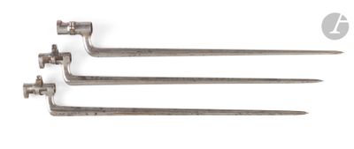 three old metal nails on a white surface with a white background
