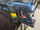 a blue and black blow gun on a black table