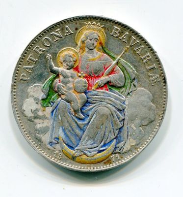 une image représentant une pièce d'argent sur laquelle figurent une femme et un enfant