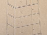 a drawing of a chest of drawers on a cardboard box