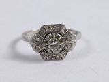 a close up of a diamond ring on a white surface