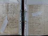 an open book with a piece of paper on it sitting on a table