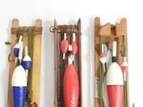 three different types of fishing buoys on the wall