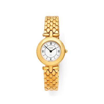 a close up of a gold wrist watch on a white background
