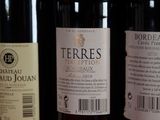 three bottles of wine sitting on top of a wooden table