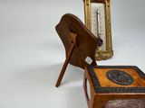 a small wooden box with a clock on top of it