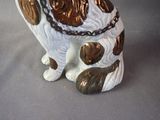 a statue of a dog with a chain around it ' s neck