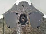 a close up of a metal object with a button on it