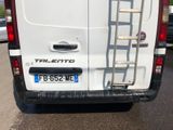 a white van with a ladder attached to the back of it