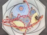 a white plate with a blue and yellow design on it