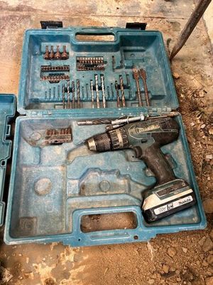 a blue tool box with tools in it on the ground