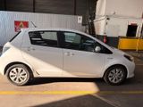 a small white car parked in a parking lot