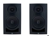 a pair of speakers sitting next to each other on a white surface