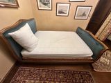 a bed that is in a room with pictures on the wall