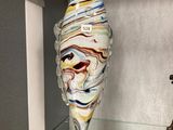a glass sculpture of a fish on display in a glass case