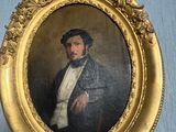 painting of a man in a black coat and white shirt in a gold frame