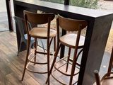 three wooden stools sitting in front of a window