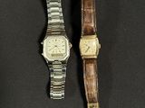 an image of a couple of watches sitting on top of a table