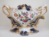a vase with flowers on it sitting on a table