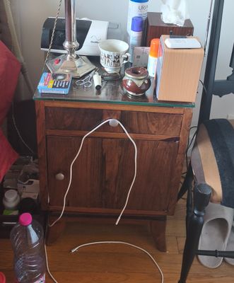 a desk with a mirror and a bottle of water on it