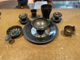 a table with a plate, cups, and spoons on it