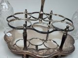 a silver plate with a wine glass holder on it